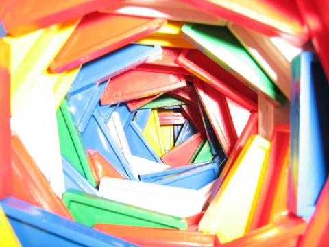 Colourful plastic domino pieces stacked in a spiral tower viewed from inside, Block Blitz