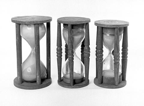 Three wooden-framed hourglasses in black and white, beat the clock in Forbidden Words